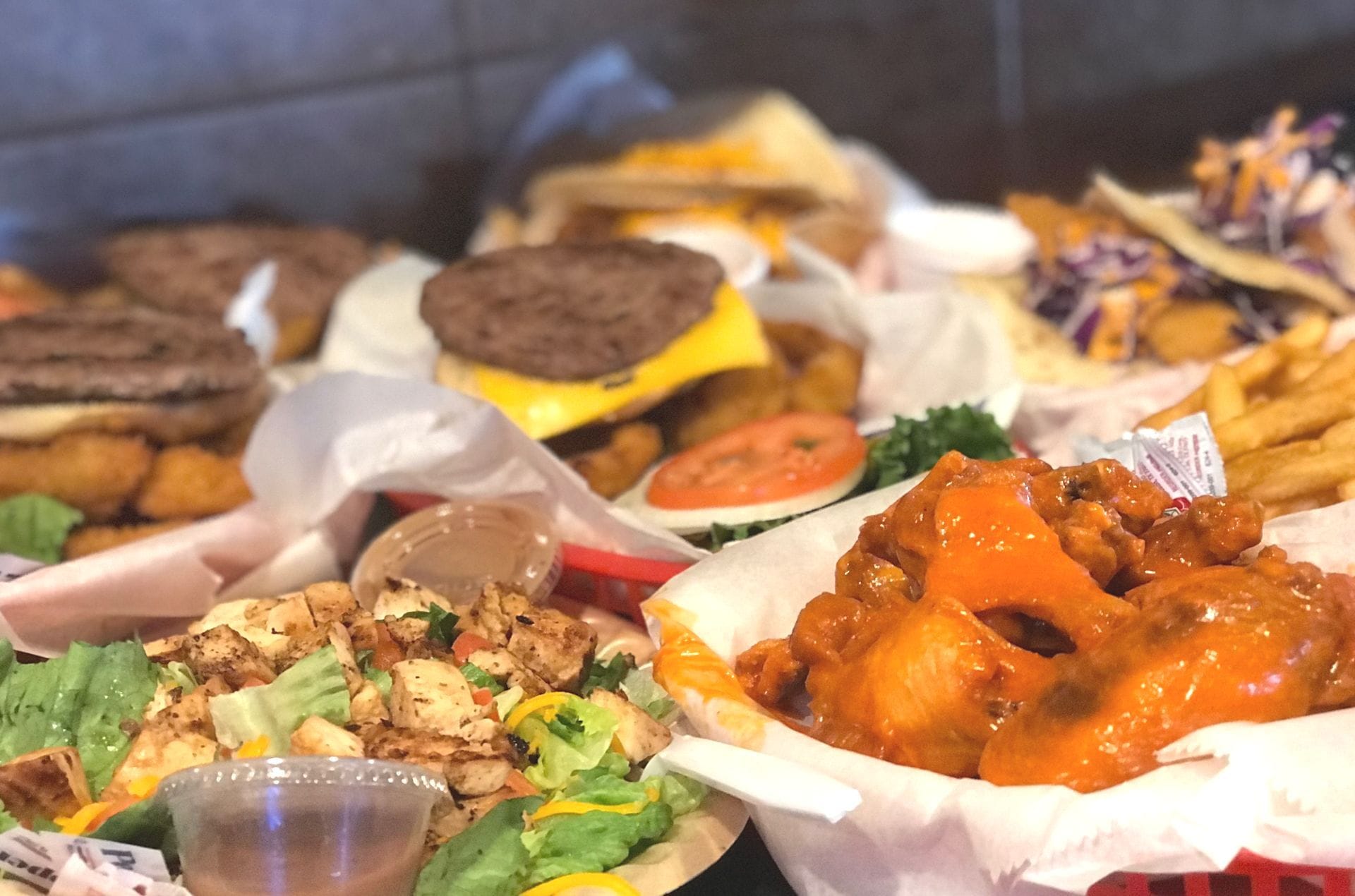 Baskets of burgers, buffalo wings, chicken salad and fries fresh from the kitchen at Papa's